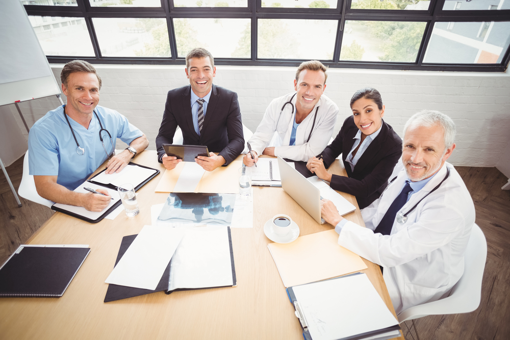Physicians and practice administrators around a conference table