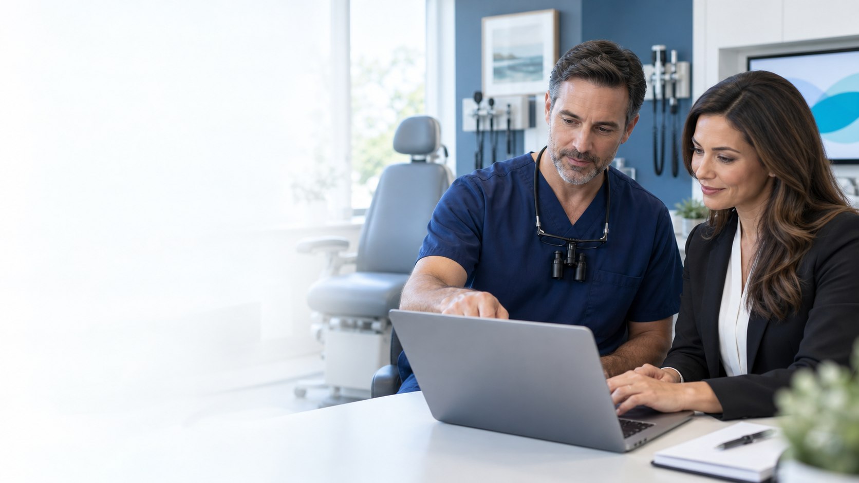 ENT physician and revenue-cycle specialist reviewing billing information